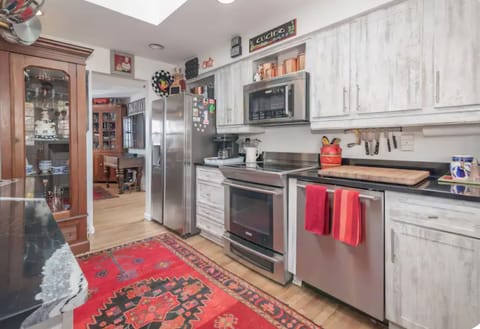 SS Side-by-side refrigerator, stove top w oven, microwave & dishwasher.