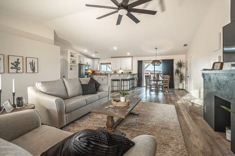 Open concept living area with a 65 inch Samsung curved flat screen TV