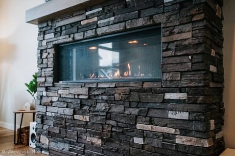 Gas fireplace with automatic climate control & remote adjustable features provide the ultimate ambiance to enjoy on a cold day