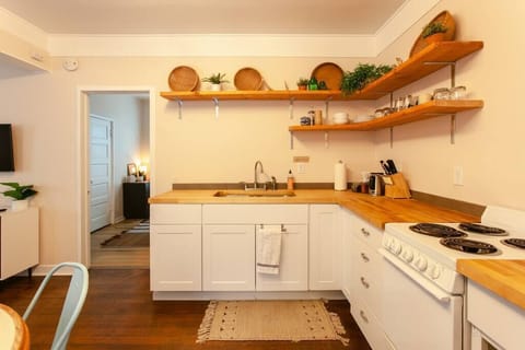 A closer look at the corner of the kitchen, showcasing wooden countertops and a functional, minimalist design.