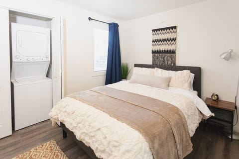 Cozy bedroom with a plush bed and in-room washer/dryer for your convenience.