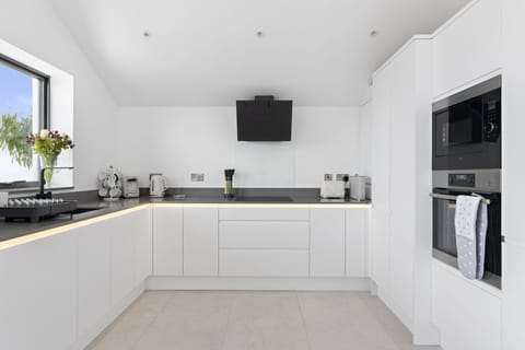 Open plan kitchen with AEG electric oven, microwave and integrated fridge & freezer
