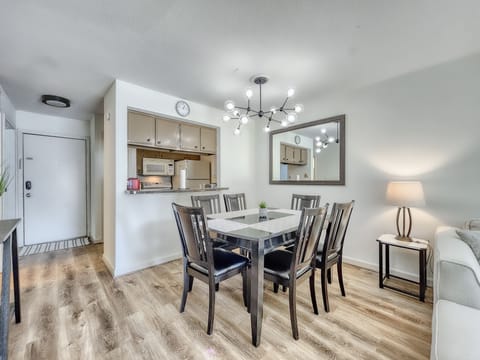 The dining area includes a large 6 person solid wood dining table