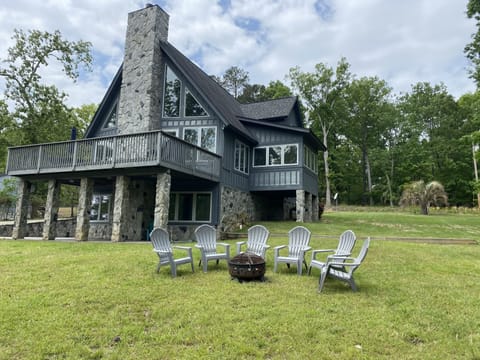 Lovely deck with grill and table up top.  Patio below. Firepit onsite as well