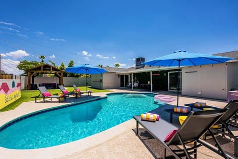 Resort-style backyard with private heated pool, pavilion & colorful mural walls