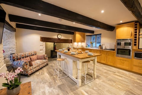 Beamed family kitchen with island and log burner, the heart of this character farmhouse.