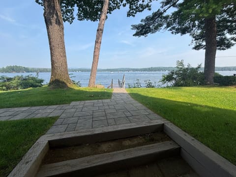 Stairs from lower level of home to the yard with a walkway