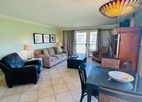Unwind in your spacious living room with comfortable seating, entertainment center, and patio doors opening to your private outdoor space.