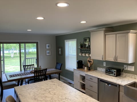 View of kichen/dining area out to the front porch area to river