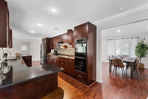 Spread out in the spacious layout of this Fort Lauderdale home, which offers 3 bedrooms & 2 full bathrooms, separate living area with a comfy sofa, a modern dining table, game room with ping pong & foosball tables, large kitchen with updated appliances and bar seating, TV's in all rooms, separate laundry room and contemporary touches throughout!