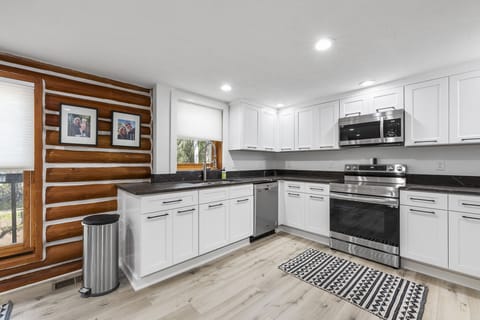 Fully stocked kitchen with stove, oven, refrigerator and coffee maker