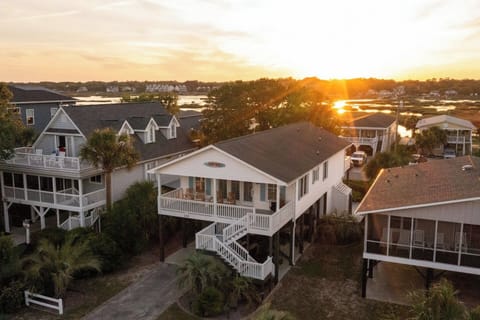 Perfectly positioned in between the ocean and the inlet this home has views on both sides of the house. Sunset water views off of the back porch. Sunrise view off of the front porch. Parking for 4 cars or 3 cars and golf cart, motorcycle, or trailer.