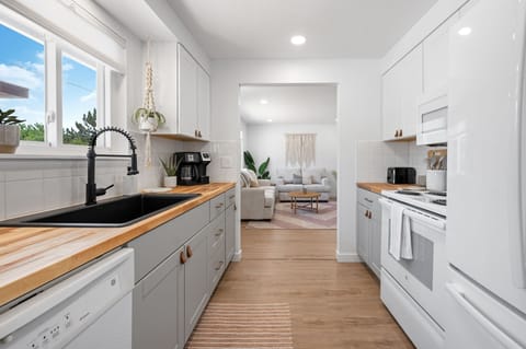 A big trough sink highlights the fully stocked  kitchen with outside views 