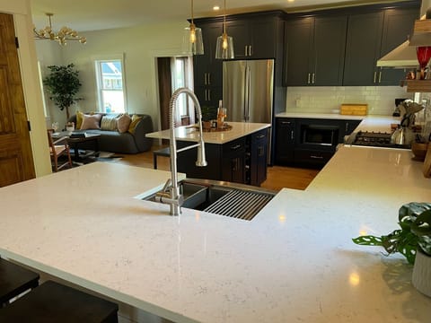Sit one one of the three peninsula barstools and gaze across this chef's kitchen.