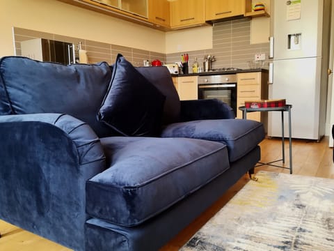 Open plan kitchen/Living room with seating for 4 people on 1 x 3 seater sofa and 1 chair