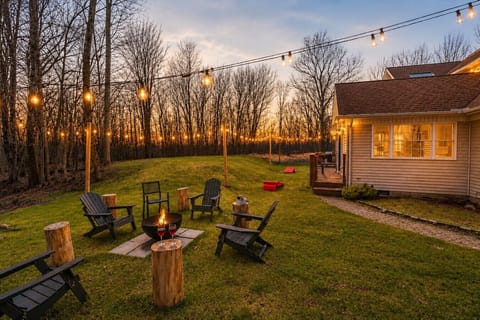 **Wood Burning Fire Pit** Grab a spot in the backyard by the fire pit, under the string lights and take in the peacefulness of the Poconos!