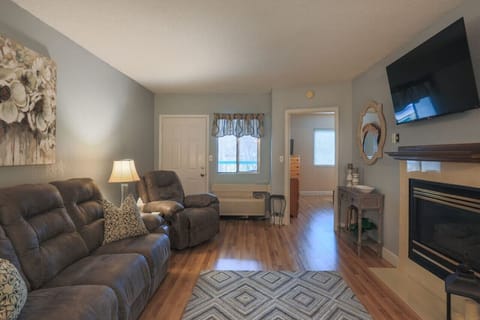 Living room view towards master bedroom and private deck with river view