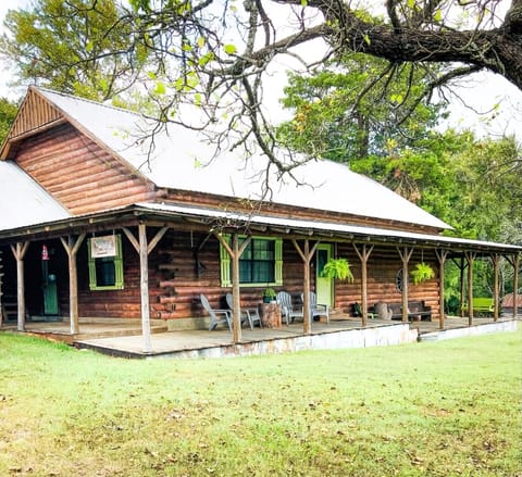 Rustic log home. Wrap around porch with beautiful green view
