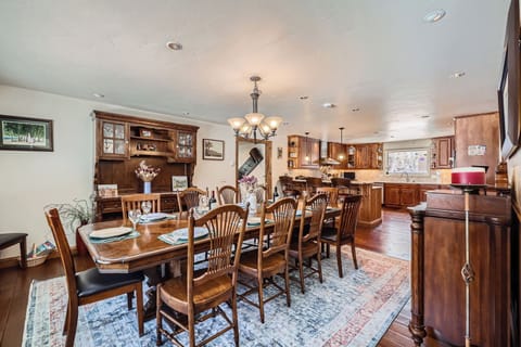 Huge dining room table with kitchen in background. Table seats up to 14.