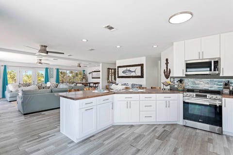 Bright kitchen featuring a large island, bar stools, & clean finishes