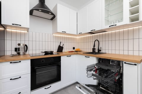 Kitchen corner with built-in oven, stylish backsplash, and a cozy functional layout.