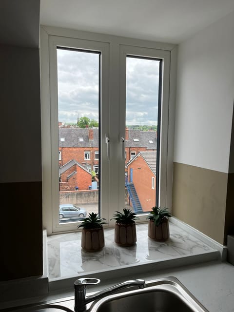 Top floor view over the rooftops to the hills
