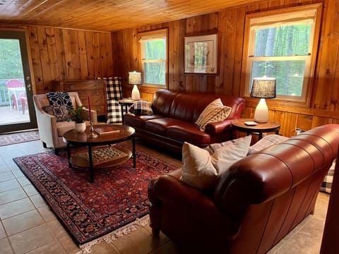 Family room with comfortable seating and sliding door to the upper deck. 