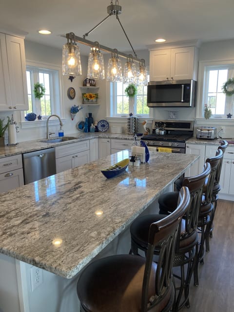 Kitchen with granite counters, new appliances Island seating for four.
