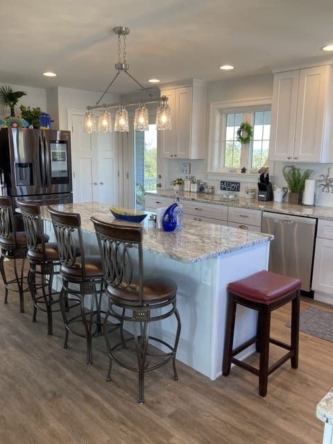 Kitchen views of the Marsh with access to back deck and screened in porch.