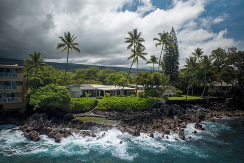 Stunning oceanfront property with dramatic waves and lush tropical landscaping