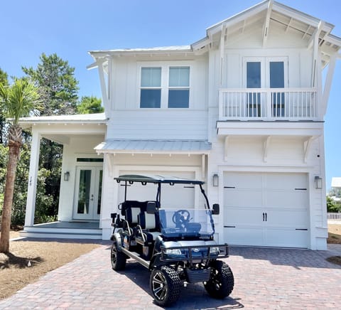 New home with a new lifted 6-seater golf cart. 2 car garage and driveway parking