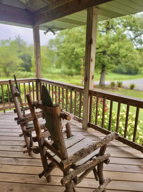 Lots of outdoor space to enjoy the lush green setting from this 3/4 wraparound porch