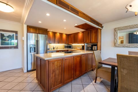 Kitchen Maytag fridge with ice, Bosch dishwasher, oven range, microwave oven.