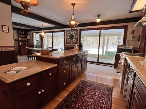 Kitchen with view to main eating area and 3-season porch. 