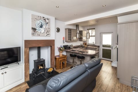 The open plan living and kitchen area is cosy and stylish, pets are also welcome at Isabel Cottage