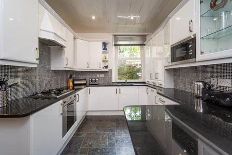 The modern kitchen is equipped with dishwasher, fridge/freezer, electric hob, oven, microwave and washing machine