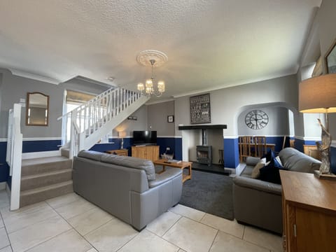 Cosy living room with log burner, the perfect place to relax after a day of exploring