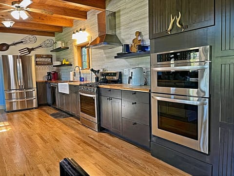 Kitchen: Culinary delight awaits with sleek appliances and charming rustic accents!