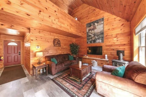 Welcome to the living room - a hub of relaxation equipped with a gas stove fireplace, bluetooth speaker, a TV with Roku device, board games, plus a comfy couch and large chair to lounge on.