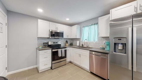 Kitchen has oven, microwave, fridge, and dishwasher