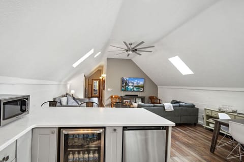 Peninsula with 3 bar stools, mini fridge, wine fridge, and microwave 