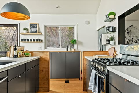 This fully equipped kitchen has a 4 burner stove, full size oven, dishwasher, microwave, Keurig coffee maker, juicer, and Nutri Bullet blender.