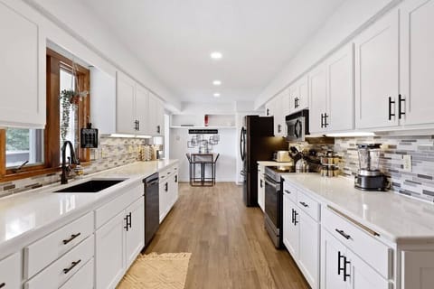 Mealtime is a breeze in this airy kitchen that opens to a charming dining nook, perfect for savoring flavors and views.