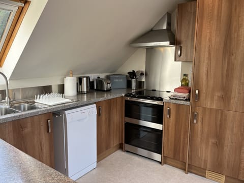 The Loft kitchen with fridge freezer, electric cooker and dishwasher