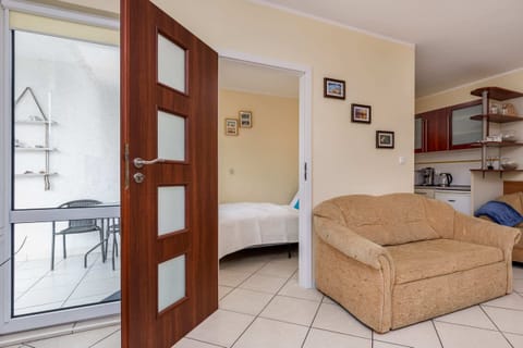 Open-plan layout showcasing the living room, dining space, and wooden doors.
