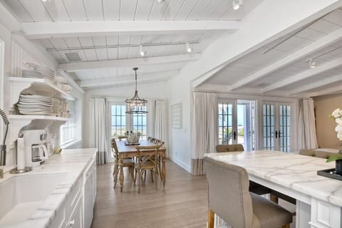 Kitchen view with dining table and island.