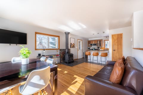 Main level living area offering a mounted Smart TV, surrounding windows, and new furnishings.
