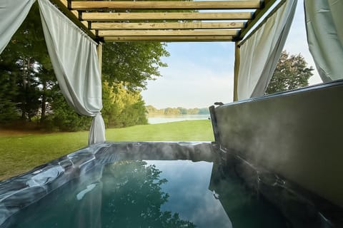 Hot tub with beautiful water views. Off the deck and same level as the home.