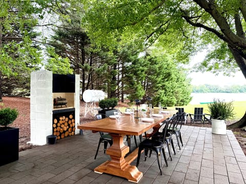 Enjoy elegant dining under the oak tree with unobstructed views of the water.