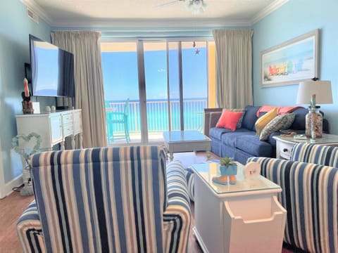 Comfortable living room with sleeper sofa, accent chairs, and large HDTV